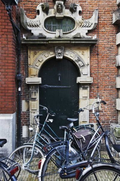 Netherlands, Amsterdam Bicycles by building door